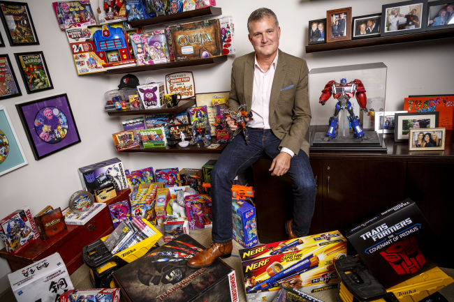 Hasbro Studios CEO Stephen Davis, holding a Transformer toy, is photographed among toys and family pictures in his office at their headquarters in Burbank, California, Oct. 14. (Los Angeles Times/MCTeye)