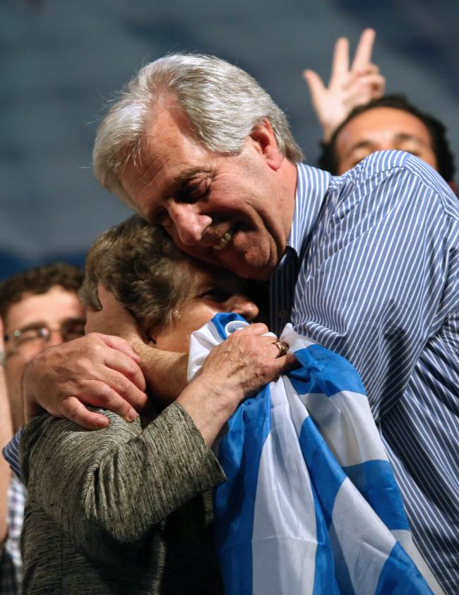 The presidential candidate for the Frente Amplio party and former president, Tabare Vazquez (right), celebrates with his wife Maria Auxiliadora Delgado after general elections in Montevideo on Sunday.    AFP-Yonhap
