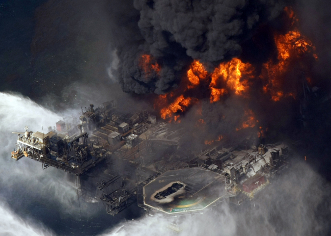 This April 2010 file photo shows the Deepwater Horizons oil rig burning in the Gulf of Mexico.   AP-Yonhap