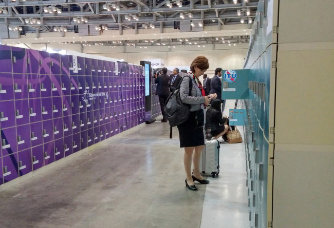 Participants at the ITU Plenipotentiary Conference 2014 held in Busan use smart lockers, developed by local digital locker company Smart Box.   Smart Box