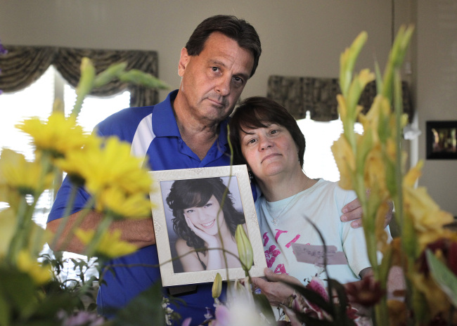 Debbie and Alan Hunter stand with flowers sent for the drug-related death of their 21-year-old daughter, Jessica, at their home in North Richland Hills, Texas, Oct. 15. (MCT)