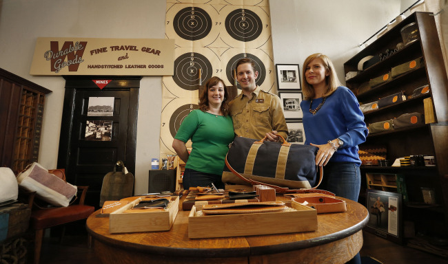 Dawn Kiefer (right), owner of Lane-Knight boutique, and Daniel (center) and Stephanie Wright of W Durable Goods, have come together to create an accessories line that is well received by consumers. (MCT)