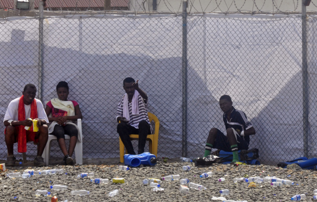 Ebola patients sit inside the Island Clinic Treatment Center in Monrovia on Wednesday.   AP-Yonhap