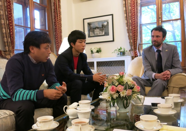 North Korean defectors Lee Geun-hyuck (left) and Lee Jeong-hyeok speak with Andrew Dalgleish (right), deputy head of the British Embassy, at the embassy.   British Embassy