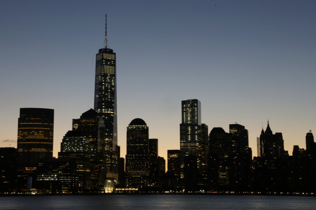 One World Trade Center dominates the lower Manhattan skyline, Monday, in this view from Jersey City, New Jersey. Thirteen years after the 9/11 terrorist attack, the resurrected World Trade Center is again opening for business, marking an emotional milestone for both New Yorkers and the United States as a whole. (Related story on Page 11)   AP-Yonhap