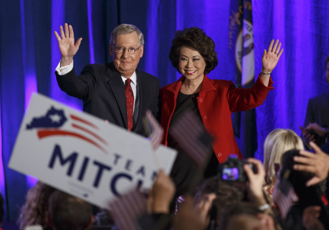 Senate Minority Leader Mitch McConnell of Kentucky, joined by his wife, former Labor Secretary Elaine Chao, celebrates with his supporters at an election night party in Louisville, Kentucky, Tuesday.   AP-Yonhap