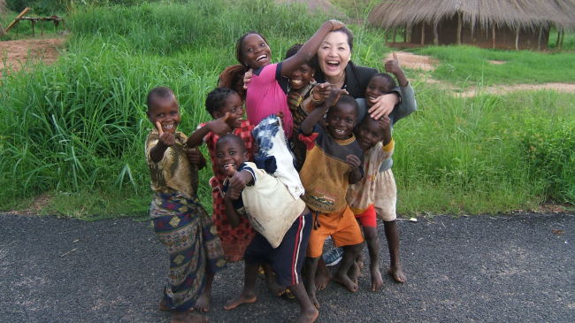 Kim Chung-ja, a retired mezzo-soprano, is surrounded by children in Karonga, northern Malawi.   Kim Chung-ja
Kim Chung-ja, a retired mezzo-soprano, is surrounded by children in Karonga, northern Malawi.   Kim Chung-ja