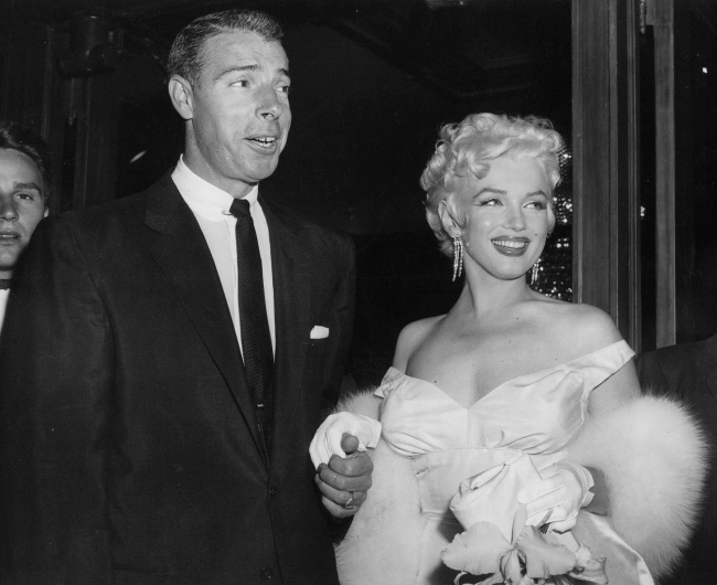 In this June 2, 1955, file photo, actress Marilyn Monroe, dressed in a glamorous evening gown, arrives at a theater with Joe DiMaggio.   AP-Yonhap