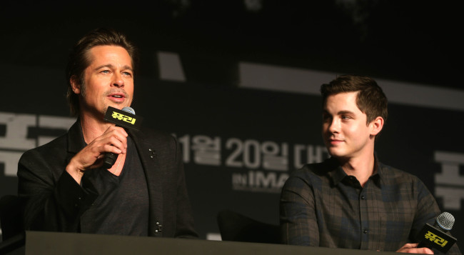 Brad Pitt (left) and Logan Lerman speak during a press conference in Seoul on Thursday.   Yonhap