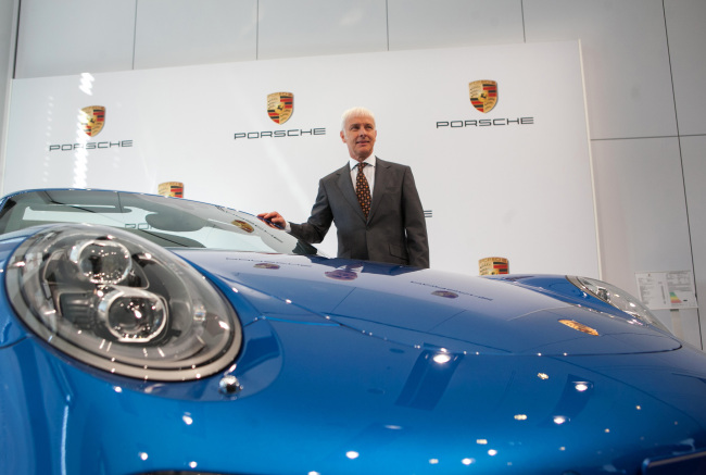Matthias Mueller, chief executive officer of Porsche AG, poses for a photograph beside a Porsche 911 Targa 4S during a recent press conference in Stuttgart.   Bloomberg