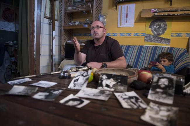 Imanol Arteaga, nephew of Spanish missionary Luis Cuartero, gestures during an interview, surrounded by photos taken on Oct. 10, 1967 by former AFP journalist Marc Hutten, showing the corpse of Ernesto “Che” Guevara displayed in the Bolivian town of Vallegrande.   AFP-Yonhap