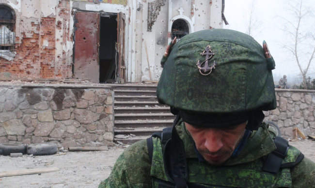 A member of the “Somali” battalion at a church that used to be under the control of Ukrainian government troops.   TASS-Yonhap