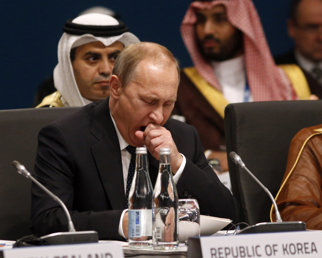 Russian President Vladimir Putin yawns at the start of the plenary session at the G20 Summit in Brisbane, Australia, Saturday.   AP-Yonhap