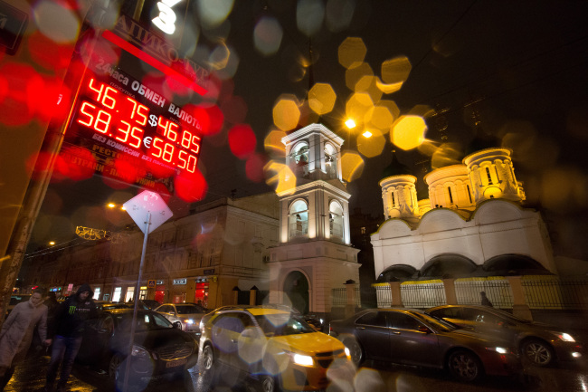 Bloomberg Photo Service 'Best of the Week': A rain covered window reflects an illuminated euro currency sign displaying foreign currency exchange rates outside a currency exchange bureau at night in Moscow, Russia, on Sunday, Nov. 9, 2014. The ruble has lost more than 28 percent against the dollar so far this year, the second-worst performance among more than 170 currencies tracked by Bloomberg. Photographer: Andrey Rudakov/Bloomberg
A rain covered window reflects an illuminated euro currency sign displaying foreign currency exchange rates outside a currency exchange bureau in Moscow.   Bloomberg
A rain covered window reflects an illuminated euro currency sign displaying foreign currency exchange rates outside a currency exchange bureau in Moscow.   Bloomberg