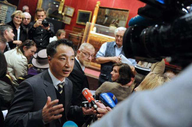Lee Tae-kyun, the South Korean buyer of one of Napoleon’s famous two-pointed hats, talks to the media in Fontainebleau, at the Osenat auction house on Sunday.   AFP-Yonhap