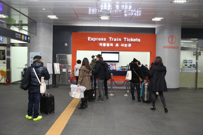 Visitors wait in line to buy tickets for the express train.   Incheon Airport Railroad Express
Visitors wait in line to buy tickets for the express train.   Incheon Airport Railroad Express
