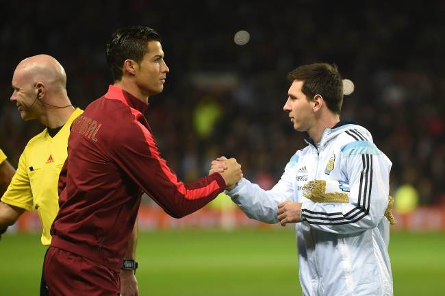 Argentina’s Lionel Messi (right) shakes hands with Portugal’s Cristiano Ronaldo ahead of their international friendly in Manchester, England, Tuesday. The two stars only played the first half as Portugal won 1-0.   AFP-Yonhap