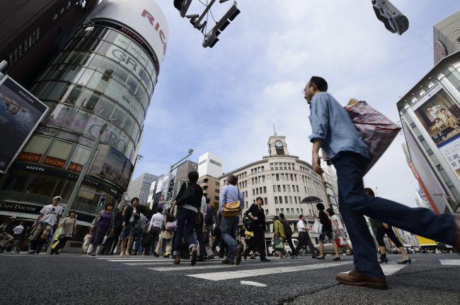 Pedestrians cross a street in the Ginza district of Tokyo.   Bloomberg