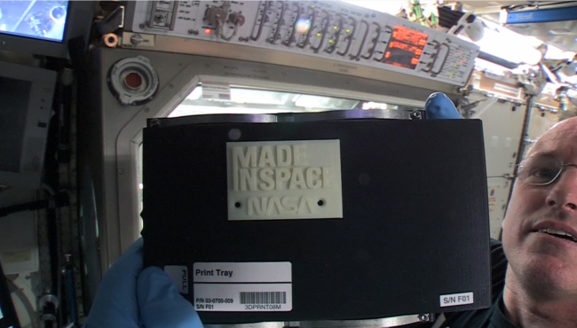 NASA astronaut Barry “Butch” Wilmore holds up the first object made in space with a 3-D printer.
AP-Yonhap