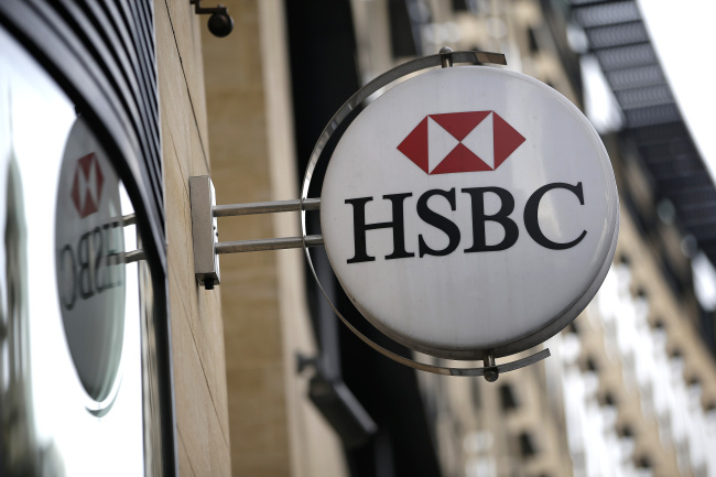 A logo hangs outside a HSBC branch in London.   Bloomberg