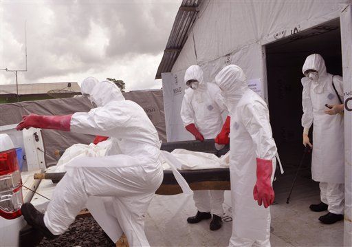 Health workers remove the body of a man who died from the Ebola virus in Monrovia, Liberia.   AP
Health workers remove the body of a man who died from the Ebola virus in Monrovia, Liberia.   AP