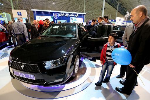 Visitors look at the new sedan Dena, manufactured by Iran’s automaker Iran Khodro, during the International Car Exhibition in the northern city of Tabriz on Oct. 14.   AFP