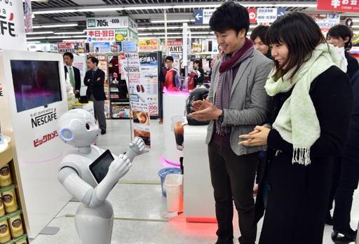 Pepper introduces customers to Nestle’s coffee machines in Tokyo.   AFP