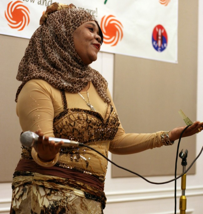 A Tanzanian woman performs in the traditional dress of Zanzibar at the East African Urafiki Party in Seoul on Saturday.   Paul Kerry/The Korea Herald