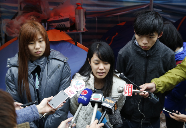 Three students speak to the media during their hunger strike in Hong Kong on Tuesday.   AP-Yonhap