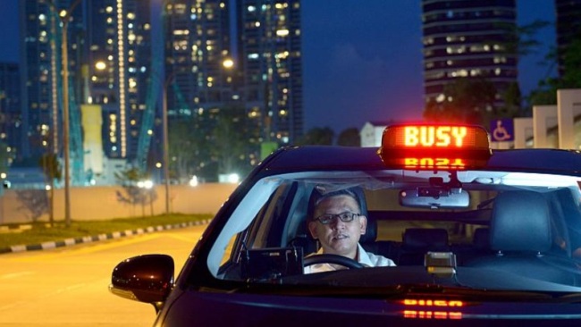 A taxi driver works a night shift in Singapore. (The Strait Times)