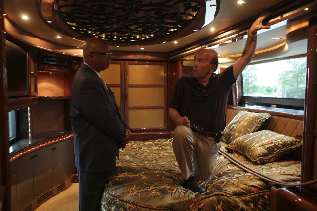 A prospective buyer talks with U.S. Marshall Kevin Carr (left), inside Rita Crundwell’s motor home at the Oak Creek
Police Department in Oak Creek, Wisconsin, July 26, 2012. (Chicago Tribune/TNS)