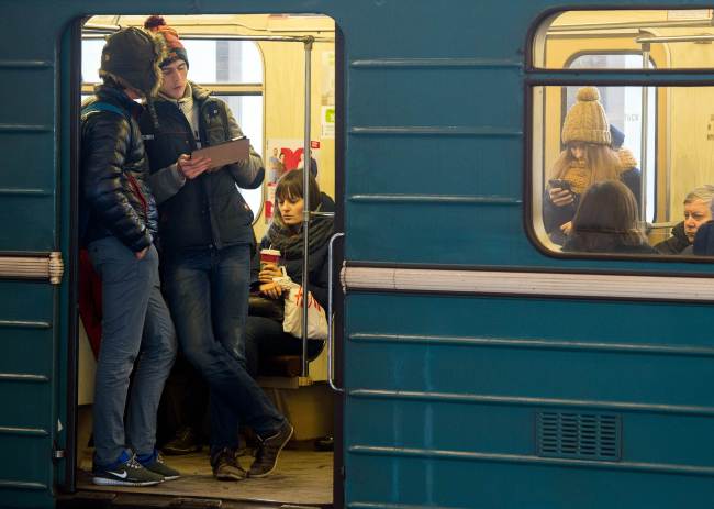 A file photo shows commuters consulting their electronic device on the Moscow Metro.   AFP-Yonhap