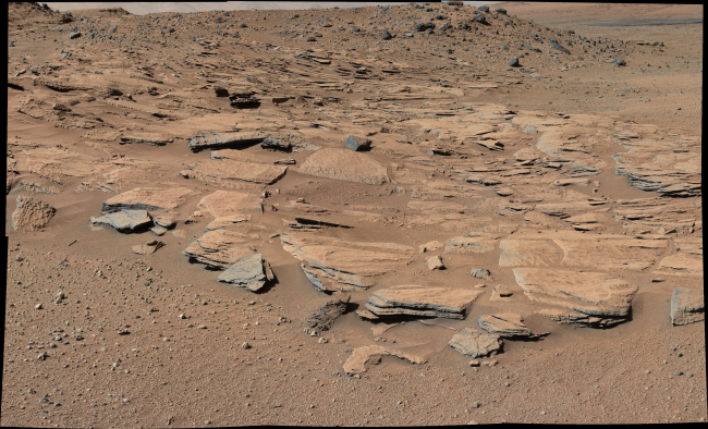 This image taken by the Mast Camera on NASA’s Curiosity Mars rover just north of the “Kimberley” waypoint shows beds of sandstone inclined to the southwest toward Mount Sharp and away from the Gale Crater rim (inset). The inclination of the beds indicates a build-out of sediment toward Mount Sharp. These inclined beds are interpreted as the deposits of small deltas fed by rivers flowing down from the crater rim to the north and building out into a lake to the south, where Mount Sharp is now.  (Related story and photo on Page 13)   NASA