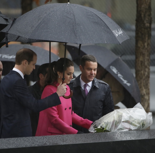 Britain’s Prince William (left) and Joe Daniels (right), president of the memorial, look on as Kate, the Duchess of Cambridge, lays flowers at the edge of a memorial pool at the National Sept. 11 Memorial in New York on Tuesday.   AP-Yonhap