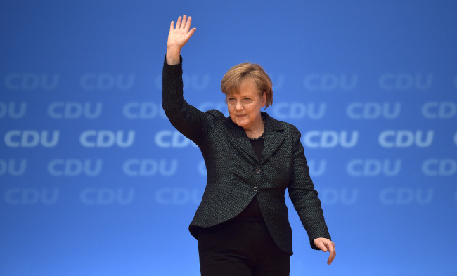 Angela Merkel, German chancellor and chairwoman of the Christian Democrats, thanks the delegates for standing ovations after her speech at the party convention in Cologne, Germany, Tuesday.   (AP-Yonhap)