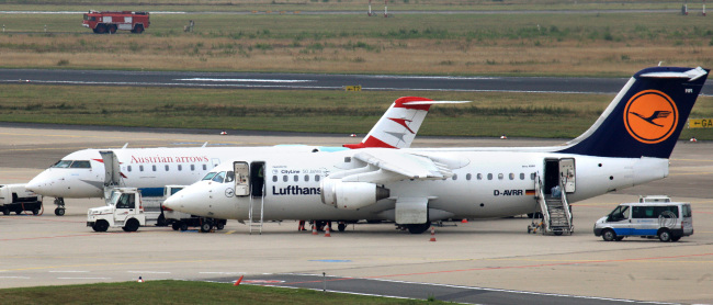 An Austrian Airlines airplane and a Deutsche Lufthansa airplane sit on the tarmac at Cologne airport in Cologne, Germany.   Bloomberg
