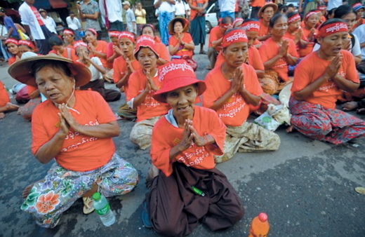 Landless Myanmar residents pray during a protest against land grabs in Yangon on Sept. 23, 2013. AFP