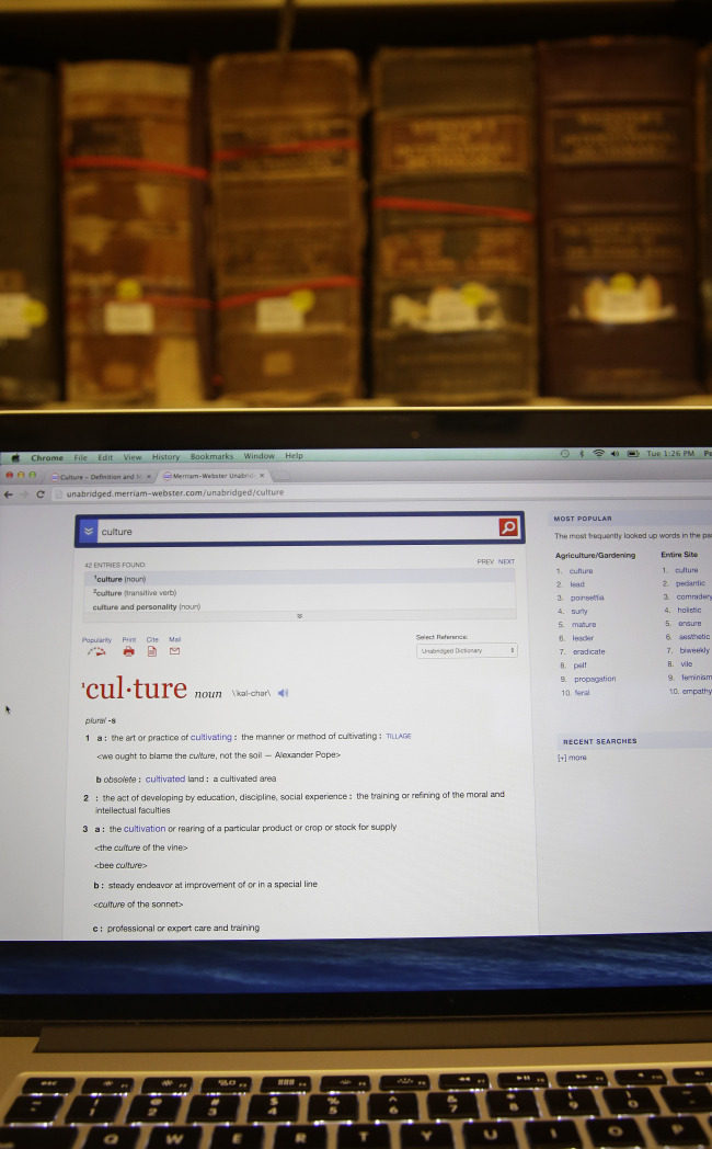Merriam-Webster’s 2014 word of the year, “culture,” appears on the Merriam-Webster website in front of old volumes of the dictionary at its publisher’s offices in Springfield, Massachusetts.   AP-Yonhap