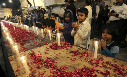 Pakistani children, chant prayers, during a candle light vigil for the victims of a Taliban attack on a school in Peshawar, organized by supporters of the Mutahida Qaumi Movement (MQM), in Karachi, Pakistan, Tuesday, Dec. 16, 2014.