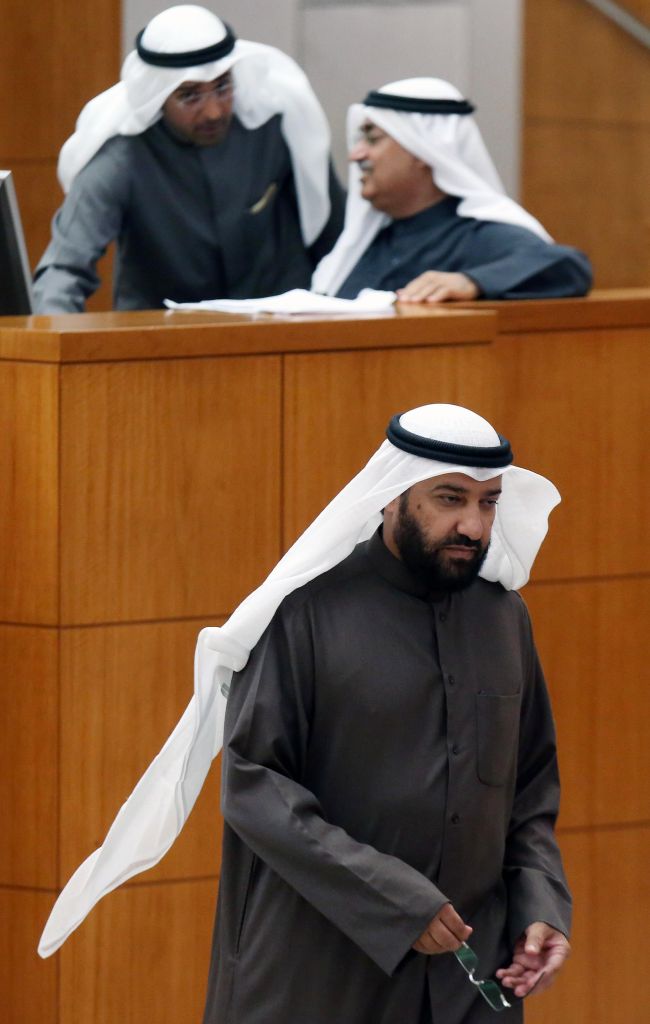 Kuwaiti oil minister Ali al-Omair (bottom) attends a Parliamentary session at Kuwait’s national assembly in Kuwait City on Tuesday.    AFP-Yonhap
