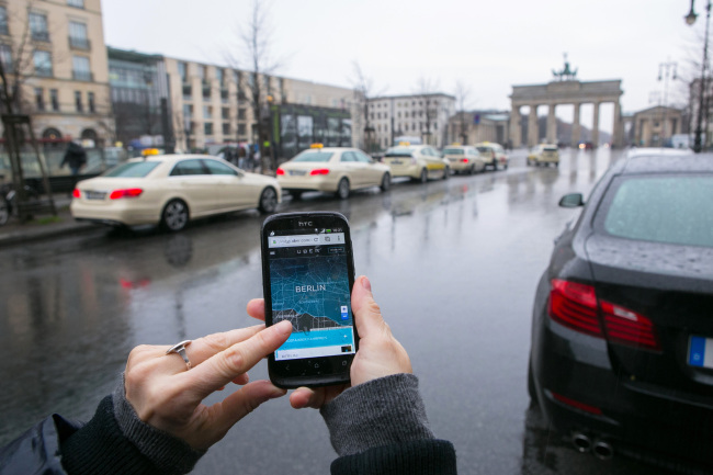 A smartphone displays the Uber Technologies car service app in Berlin, Germany.   Bloomberg