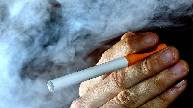 This file photo shows a person posing with an electronic cigarette,
or e-cigarette.(AP)