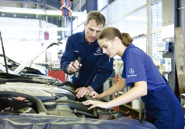 Technicians inspect a Mercedes-Benz car at a certified collision repair center.   Mercedes-Benz Korea