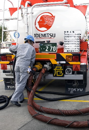 A tank truck driver pumps out gasoline into reserve tanks at an  Idemitsu Kosan gas station in Tokyo.   Bloomberg
