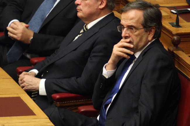 Greek Prime Minister Antonis Samaras reacts during the first round of voting for the Greek President, at the Greek Parliament, in Athens.   EPA-Yonhap