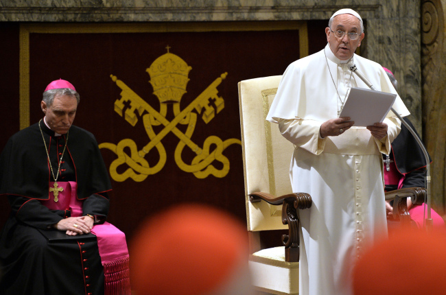 Pope Francis delivers his message during a meeting with cardinals and bishops of the Vatican Curia during the exchange of Christmas greetings in the Clementine Hall at Vatican on Monday.   AP-Yonhap