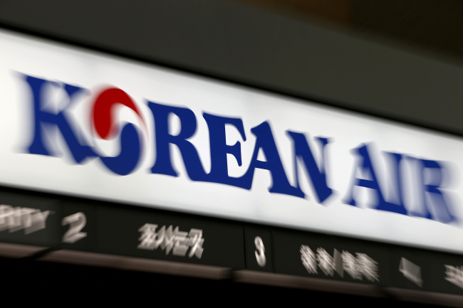 A Korean Air logo is displayed above the carrier’s counter at Incheon International Airport.    Bloomberg