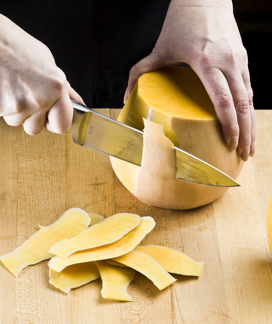 Peeling squash: Place the knife blade at the top of the squash, just inside the peel. Slide the knife downward, cutting away the peel. Turn and repeat. (Tribune Content Agency)