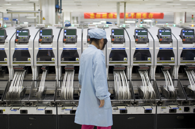 An employee works in a manufacturing facility at ZTE’s headquarters in the Nanshan district of Shenzhen, China.   Bloomberg