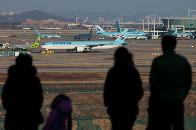 People look at Korean Air passenger planes at Incheon International Airport in Incheon.   Bloomberg